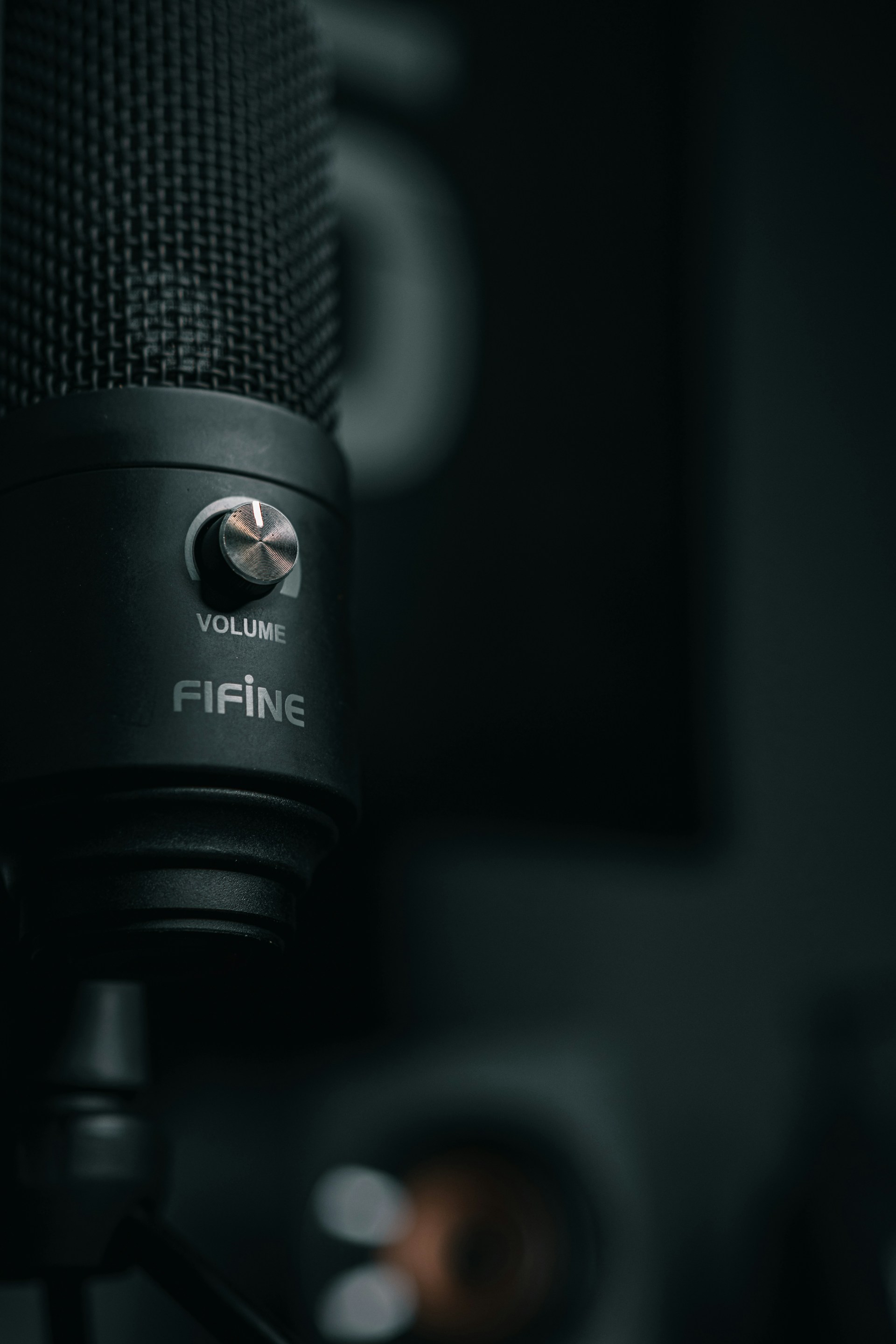 a close up of a microphone with a black background