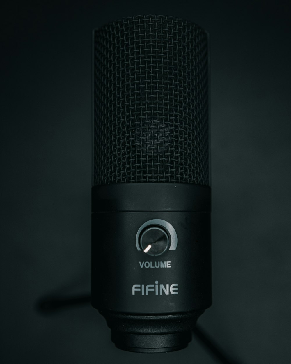 a black microphone with a black background