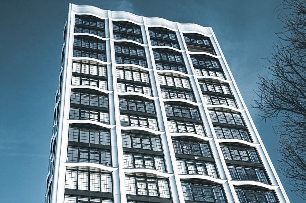 a tall white building with lots of windows