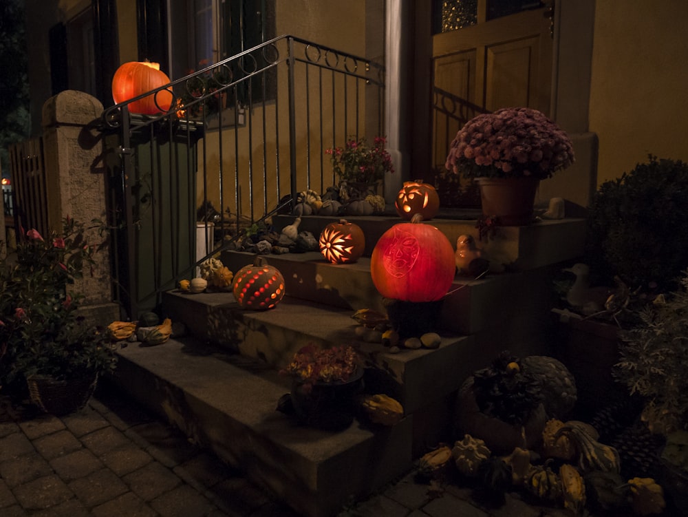 a set of steps decorated with pumpkins and flowers