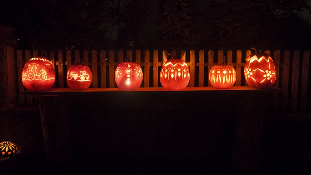 a group of carved pumpkins sitting on top of a table