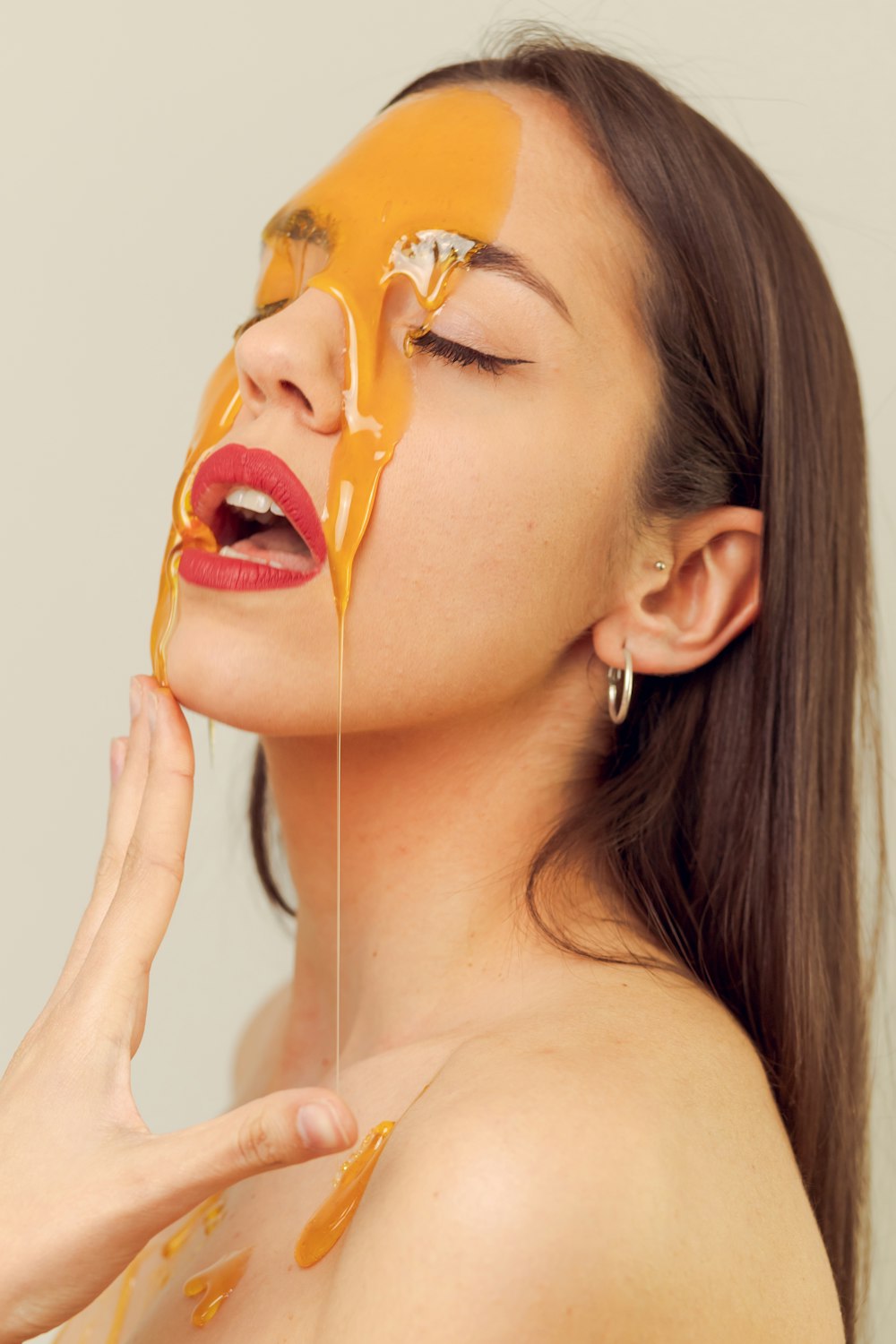 a woman with a yellow substance on her face