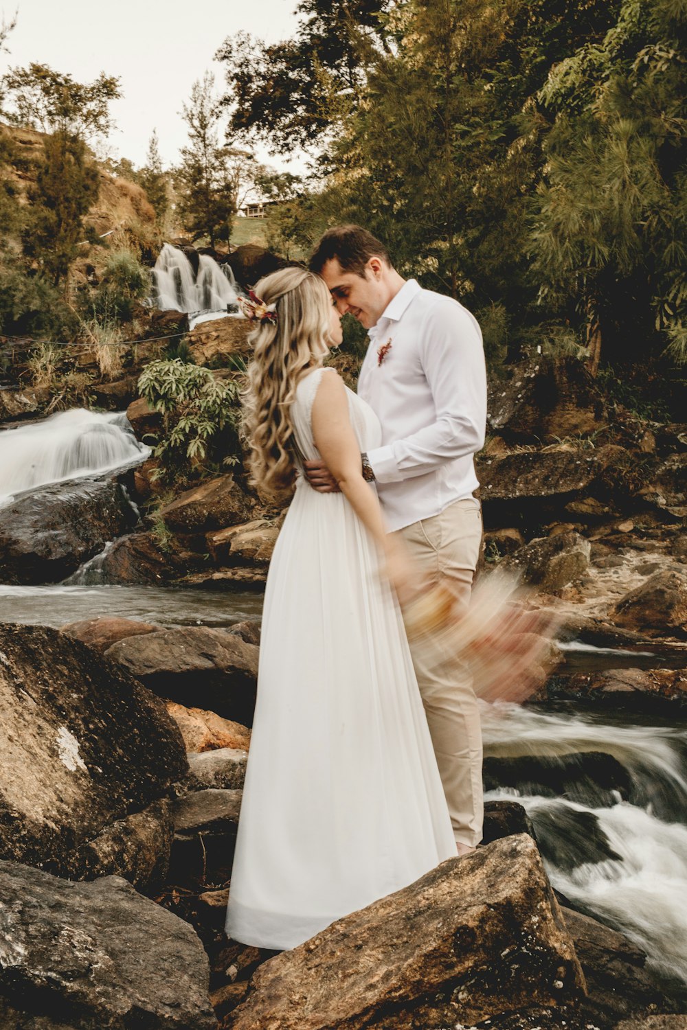 a man standing next to a waterfall