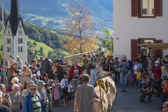 Community members gathered outdoors during a local cultural event in a village setting.