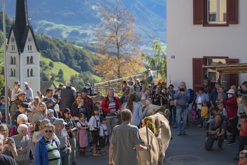A group of people gathered outdoors in a village setting.