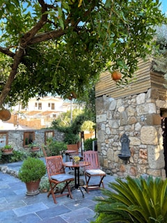 A traditional Armenian guesthouse courtyard with colorful flowers and inviting seating