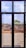 A construction site is viewed through a window with several panes. Workers are engaged in building activities, surrounded by piles of earth and construction materials. The sky is partly cloudy, and some greenery is visible in the background.