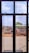 A construction site is viewed through a window with several panes. Workers are engaged in building activities, surrounded by piles of earth and construction materials. The sky is partly cloudy, and some greenery is visible in the background.