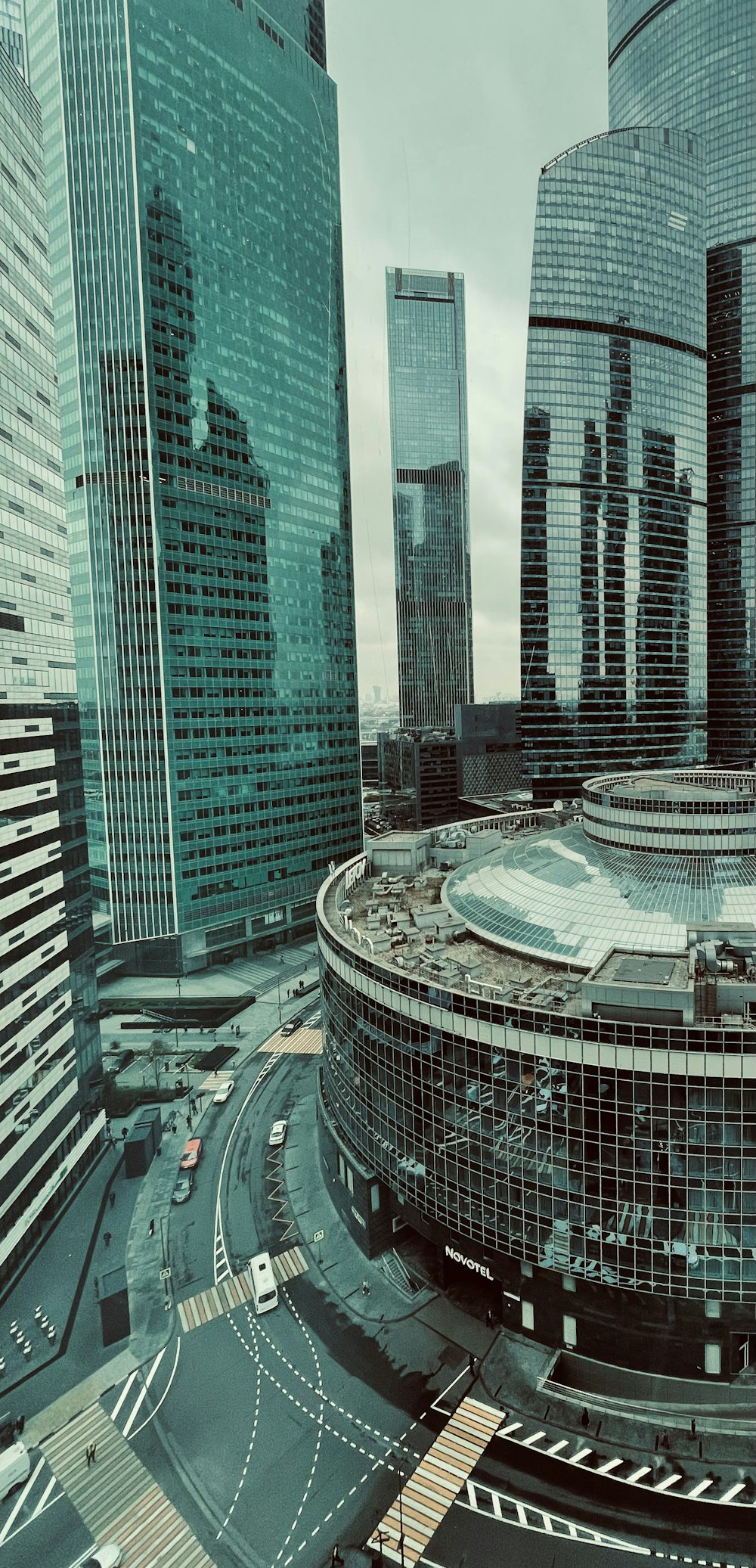 a large circular building surrounded by tall buildings