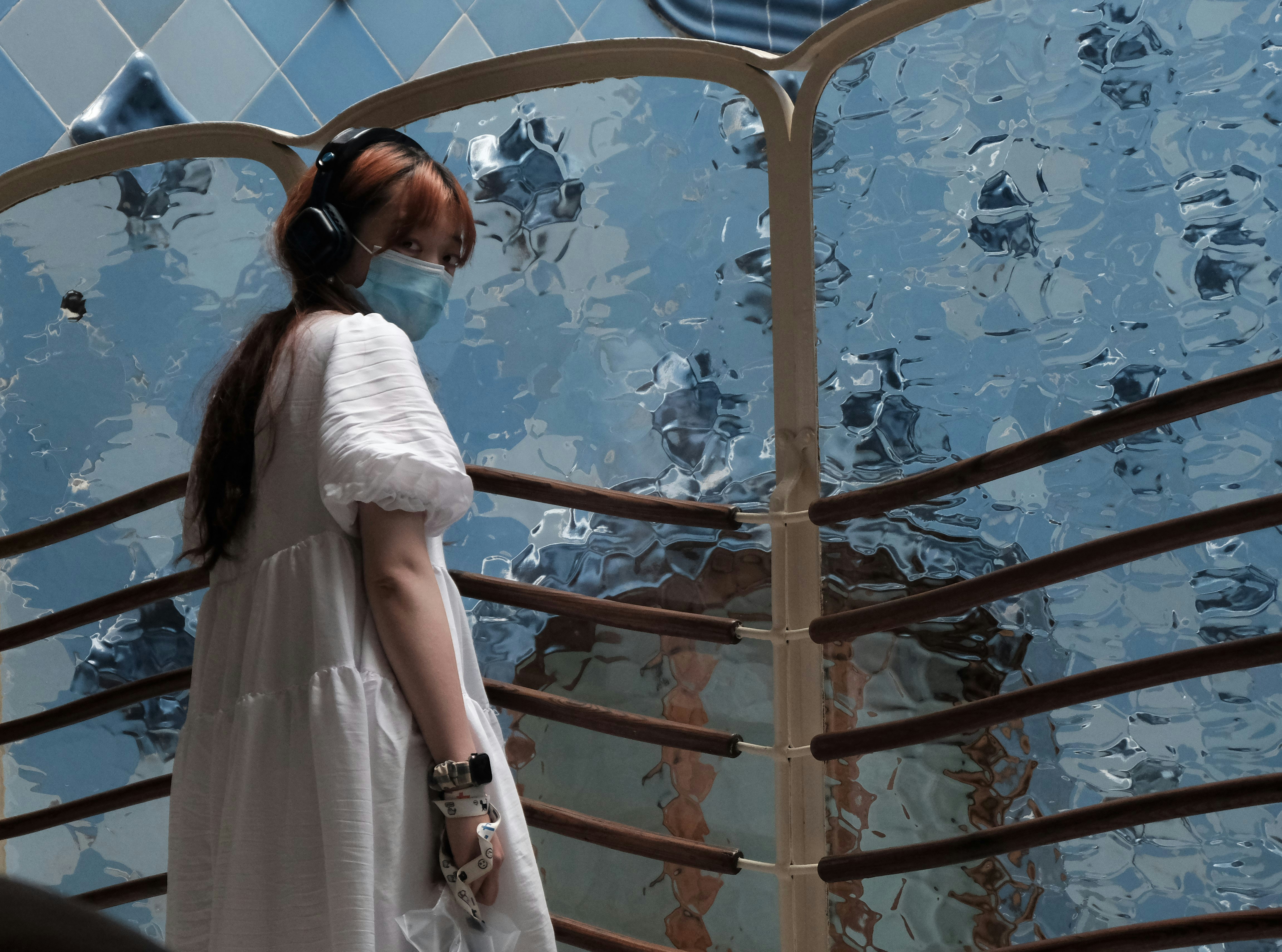 a woman in a white dress and a face mask