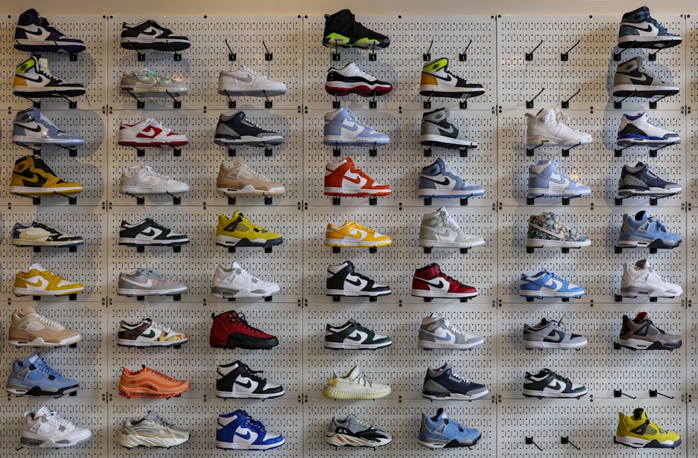 a display of various shoes on a wall