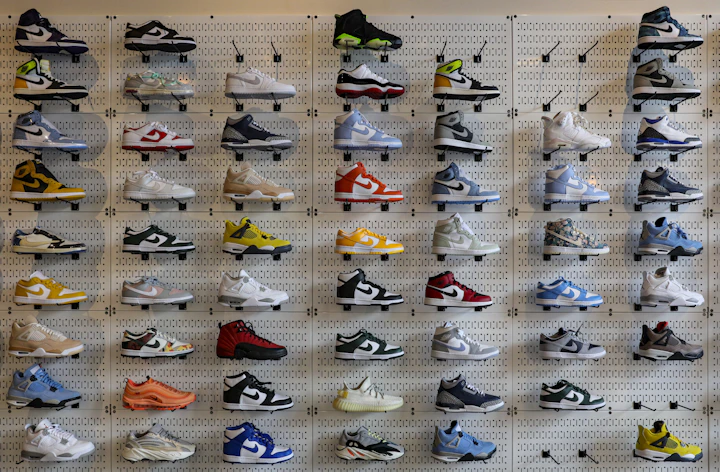 Wall display of sneakers sorted by brand inside a streetwear consignment store