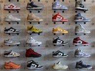 A minimalist display of various sneaker designs on a clean surface.