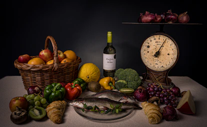 a table topped with a plate of food and a bottle of wine