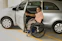 A smiling elderly woman sitting comfortably in a wheelchair inside a clean, accessible vehicle.