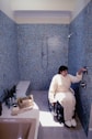 a person in a wheelchair in a bathroom