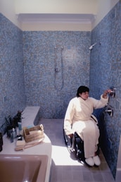 a person in a wheelchair in a bathroom