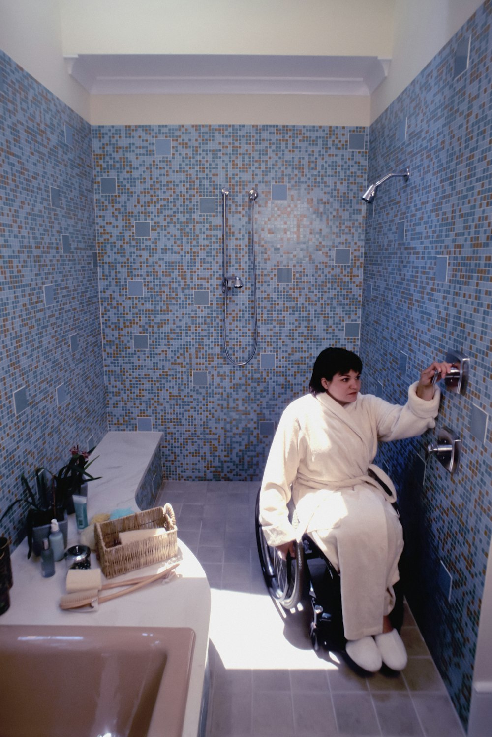 a person in a wheelchair in a bathroom