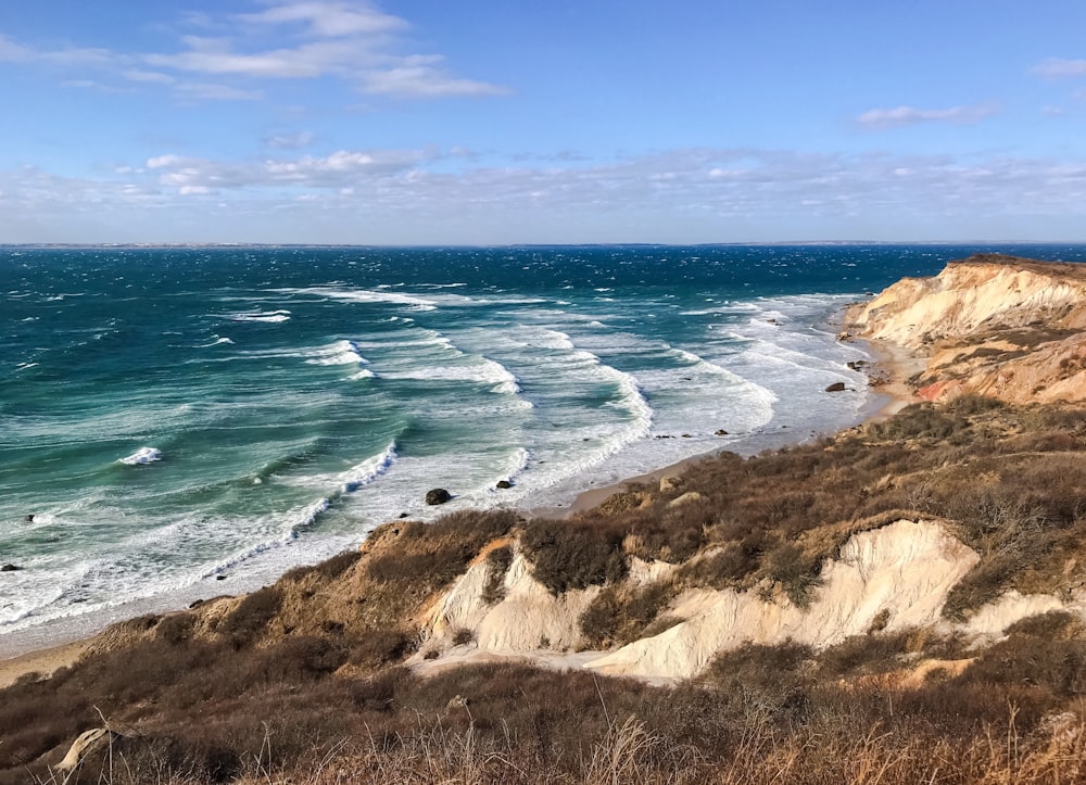 a view of the ocean from the top of a hill