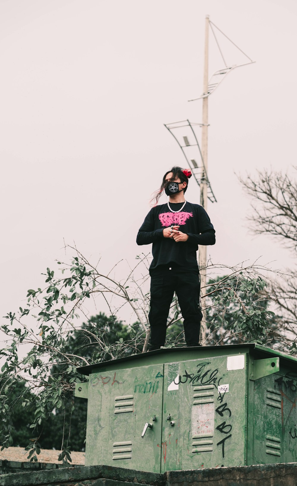 a man standing on top of a green box