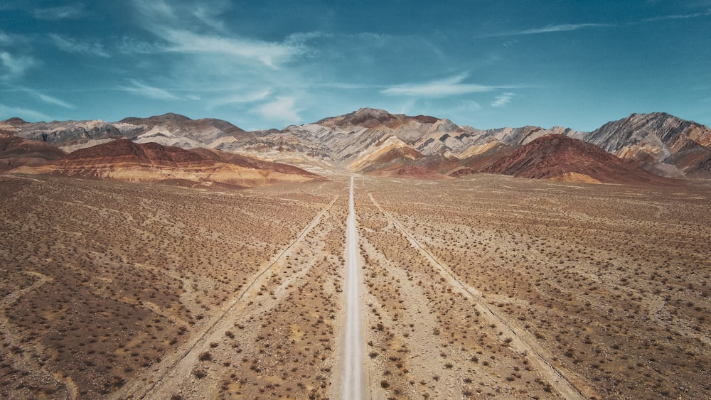 an aerial view of a road in the middle of the desert