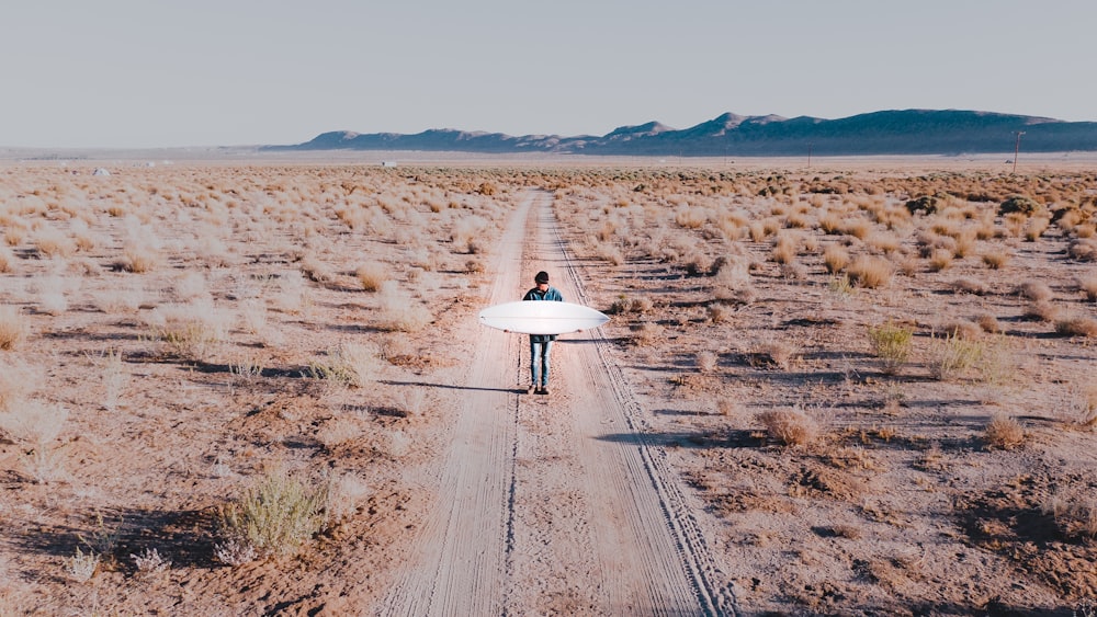 a person riding a bike down a dirt road