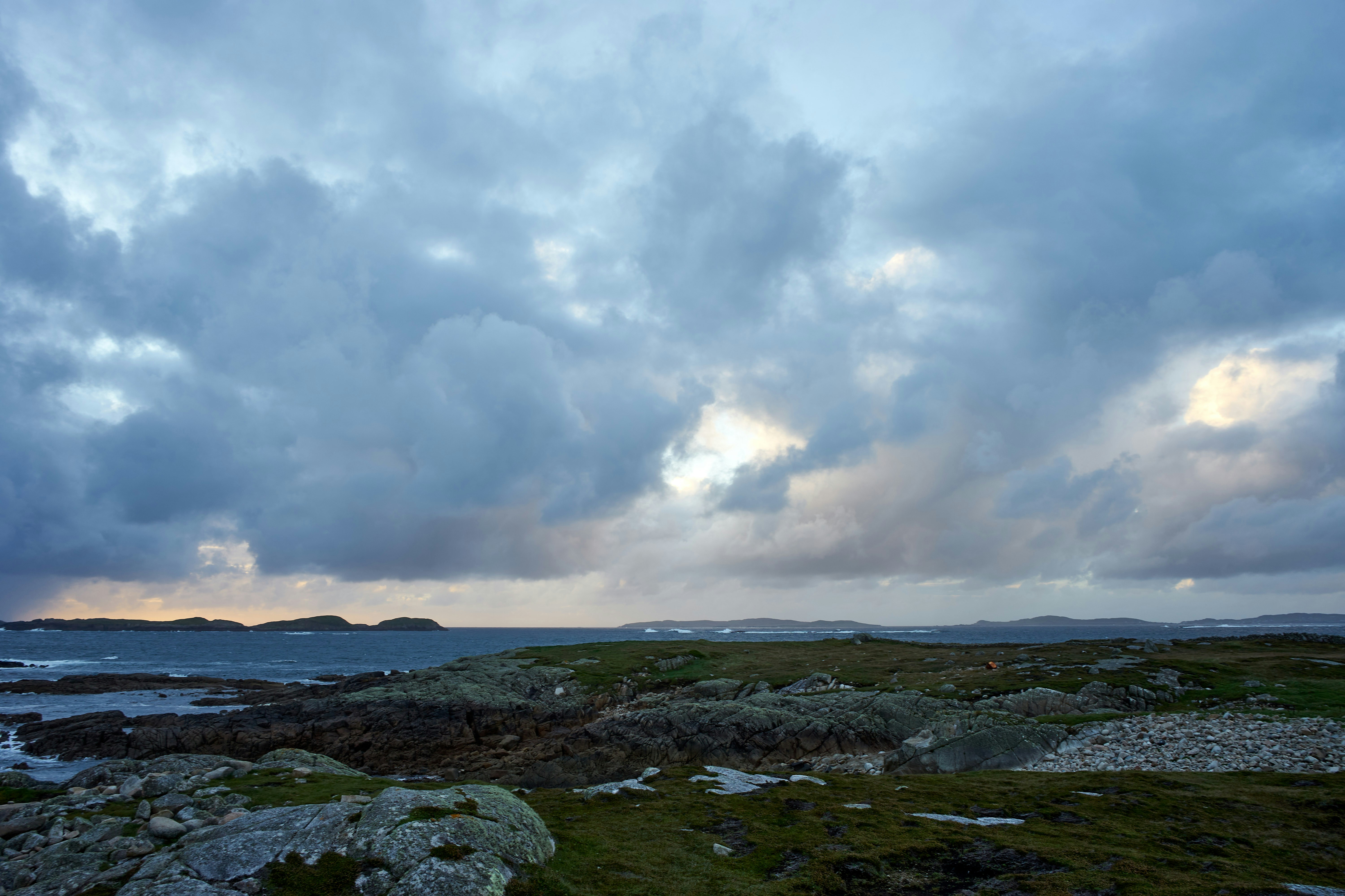 a large body of water under a cloudy sky