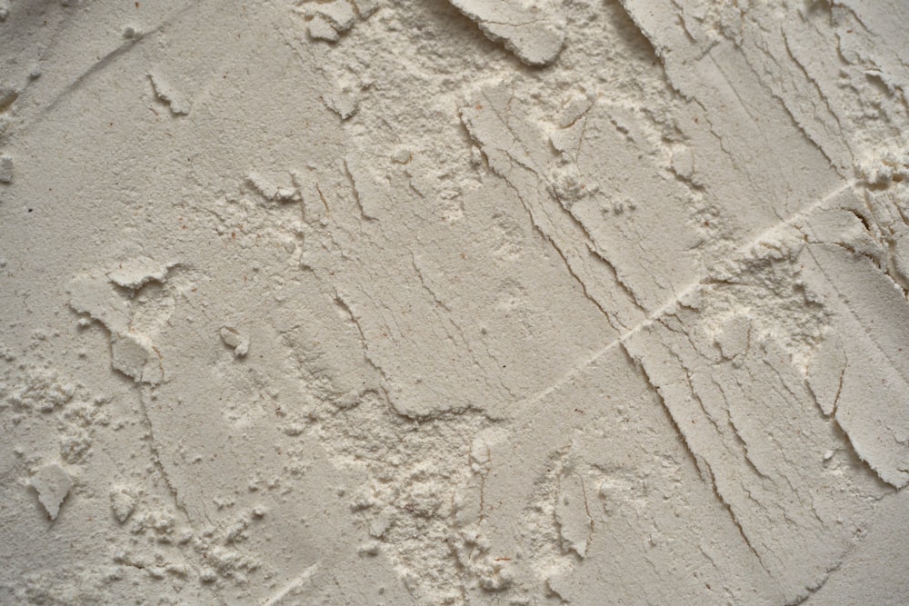 a close up of a wall with white paint