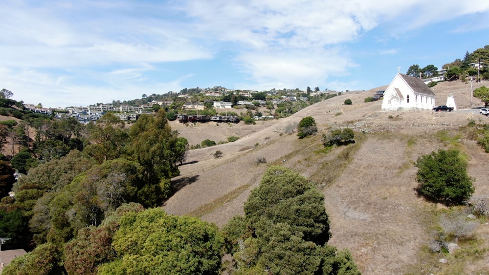 a church on a hill surrounded by trees