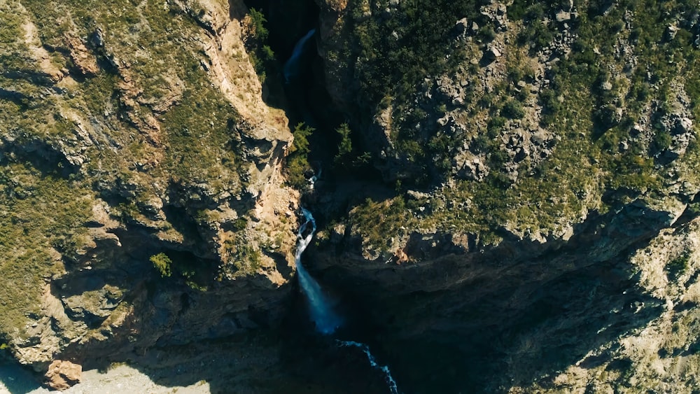 an aerial view of a waterfall in the mountains