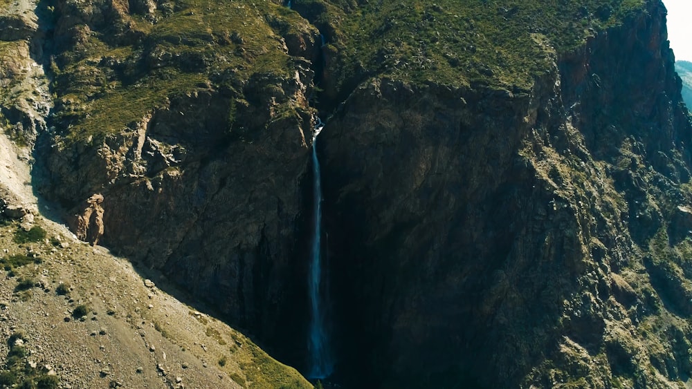 a large waterfall in the middle of a mountain