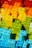 A collection of colorful building blocks arranged in a gradient pattern, showcasing a spectrum from red and orange at the top to green and blue at the bottom.
