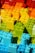 A collection of colorful building blocks arranged in a gradient pattern, showcasing a spectrum from red and orange at the top to green and blue at the bottom.