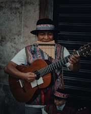 a man in a mexican outfit playing a guitar