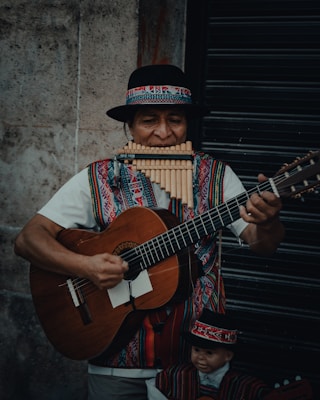 a man in a mexican outfit playing a guitar