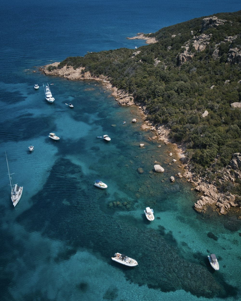 a group of boats floating on top of a body of water