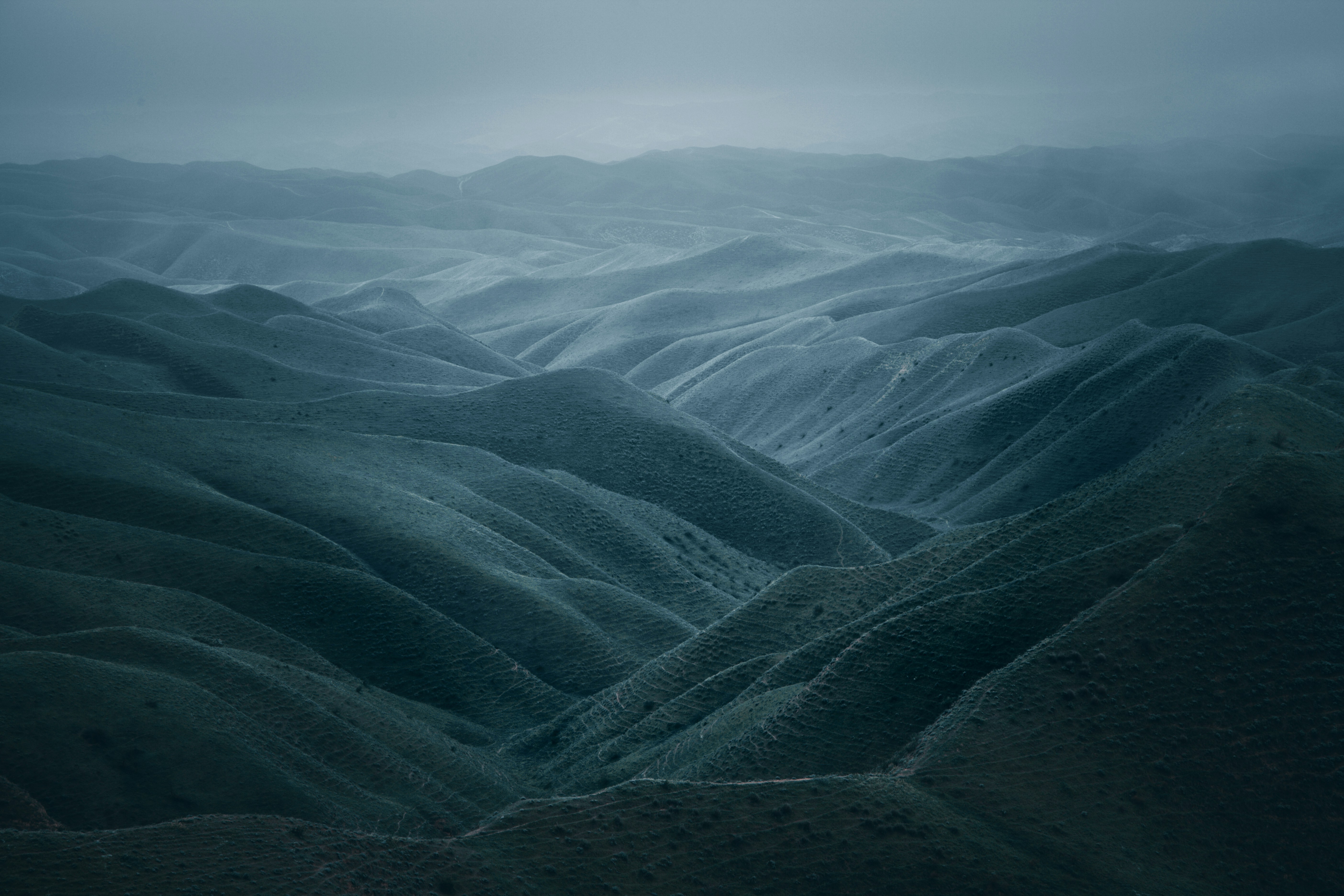 a view of a mountain range in the fog