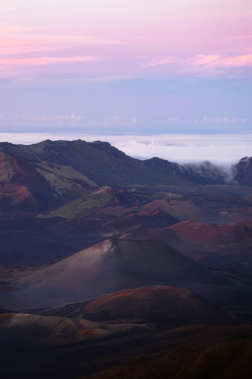 a view of a mountain range with clouds in the distance