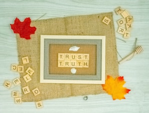 A mural comprised of scrabble letters forming the words "trust" and "truth"