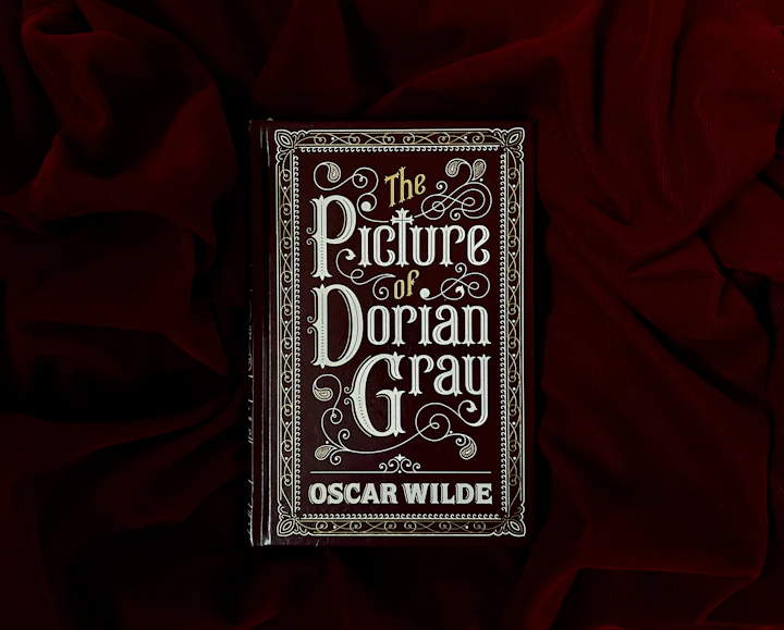 A single hardcover book photographed on a deep red cloth backdrop