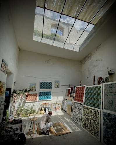 a man sitting on a rug in a room