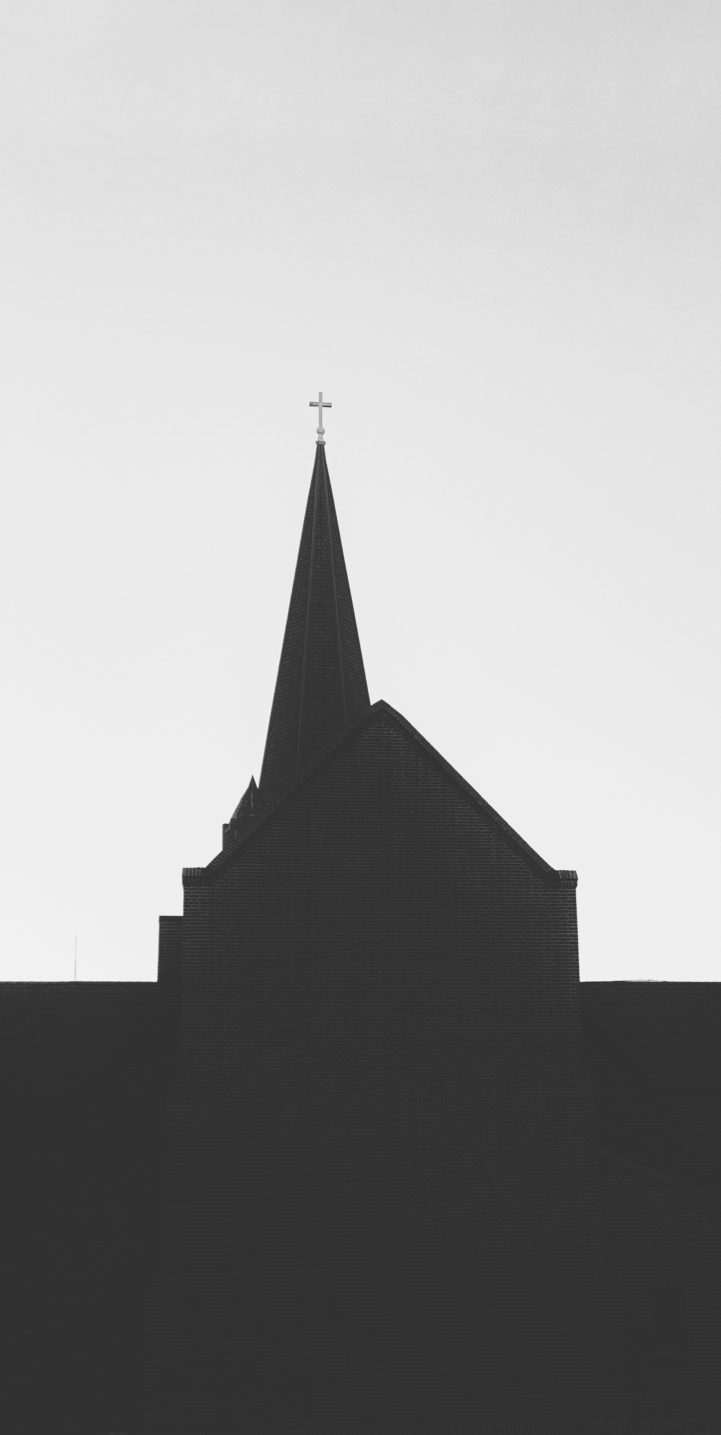 a black and white photo of a church steeple