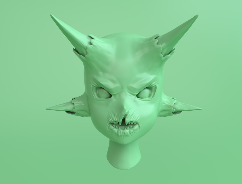 a green mask with horns and fangs on it