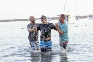 a group of people standing in a body of water