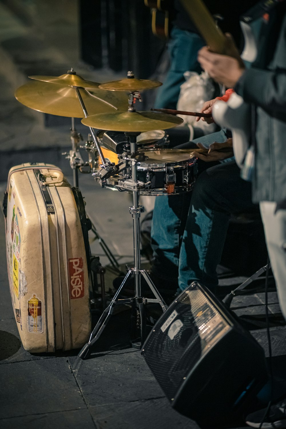a man is playing drums on the street