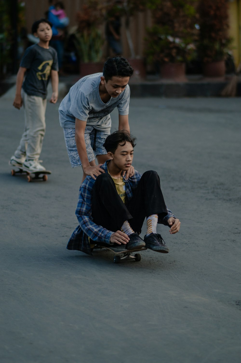 a group of young men riding skateboards down a street