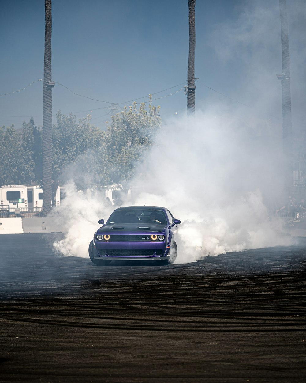 a blue car with smoke coming out of it