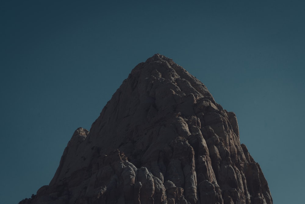 a very tall mountain with a clear sky in the background