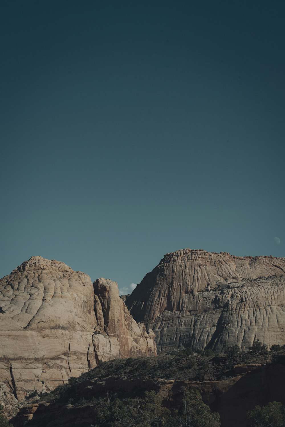 a couple of mountains with a sky in the background