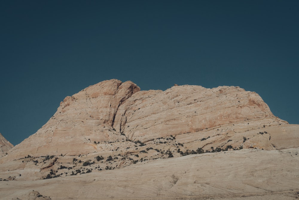 a large rock formation in the middle of a desert